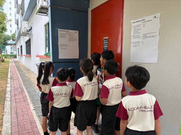 Working together to solve Mathematics and Science questions in the Total Defence Treasure Hunt.